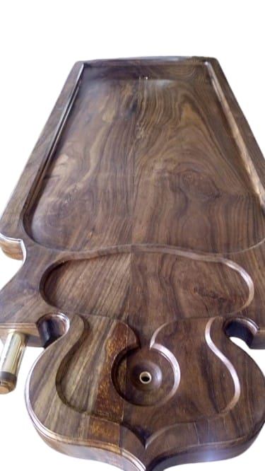 Vedadhara Sharira Peetha — a carved rosewood body cradle with a lyre-shaped scalloped rim and oil-drainage channel